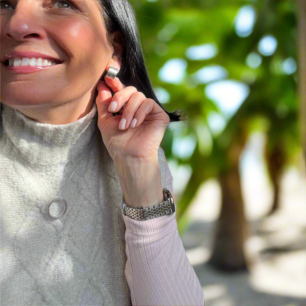 woman showing handmade earrings