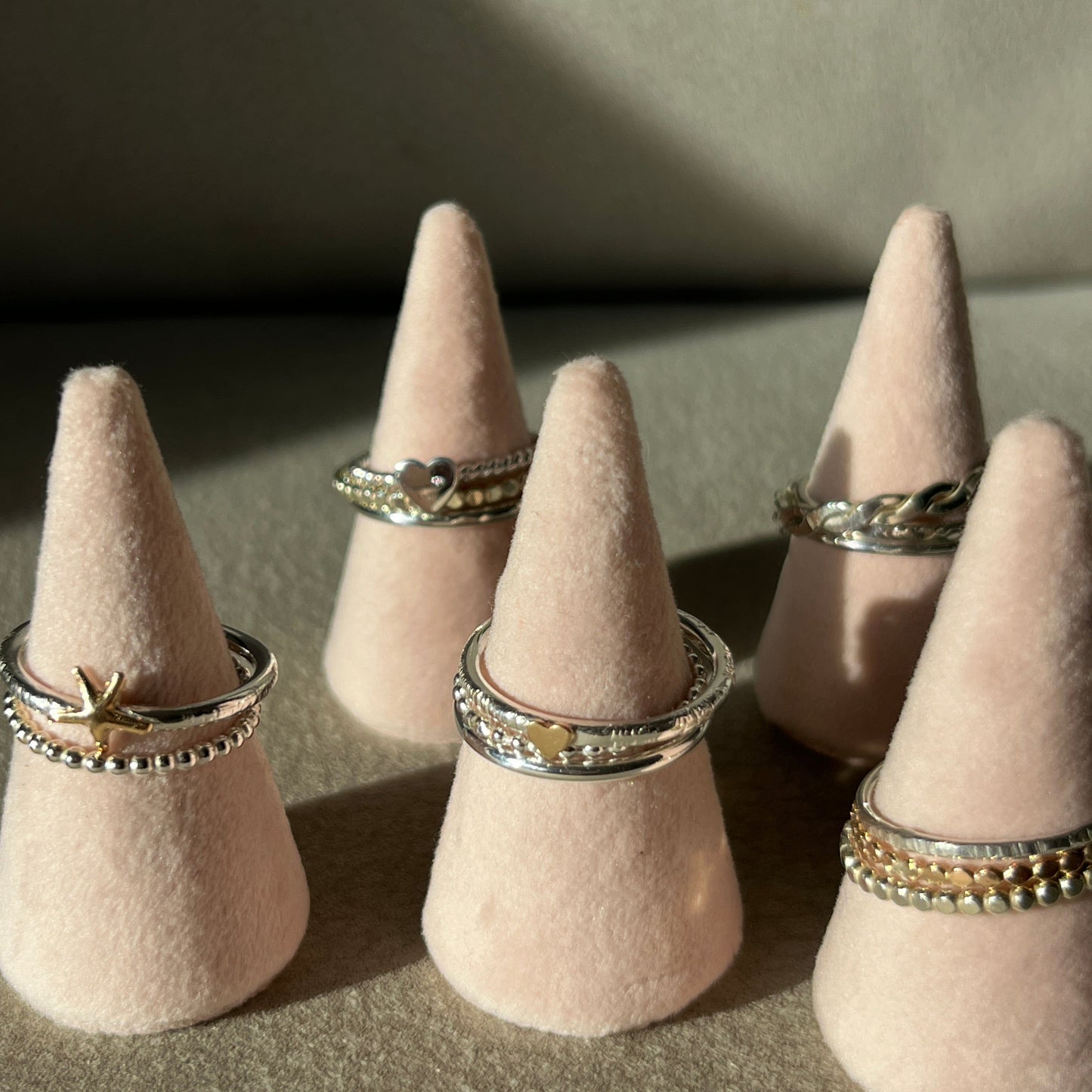 pink display cones showing the stacking ring range every ring from the collection stacked on six cones all of which are handmade in Dublin