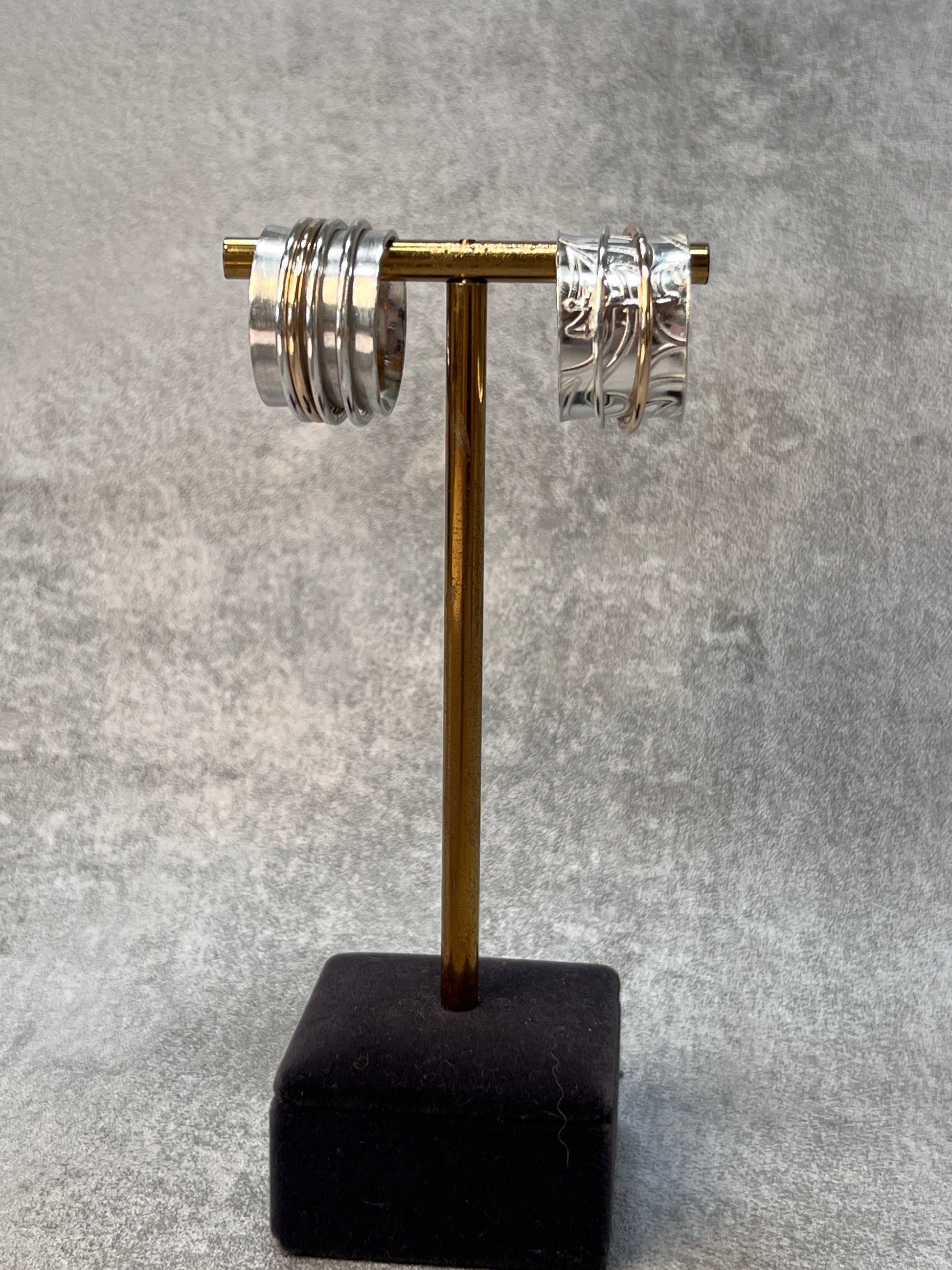 two spinner rings on a jewellery stand