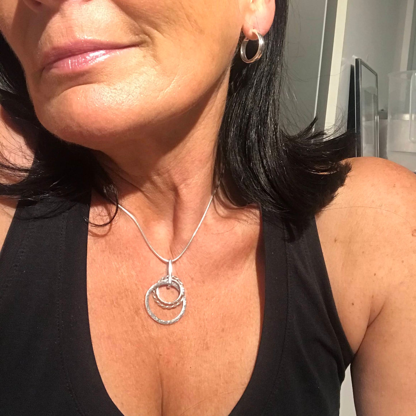 sterling silver hoop earrings size 16mm in circumference worn by the maker black sports top