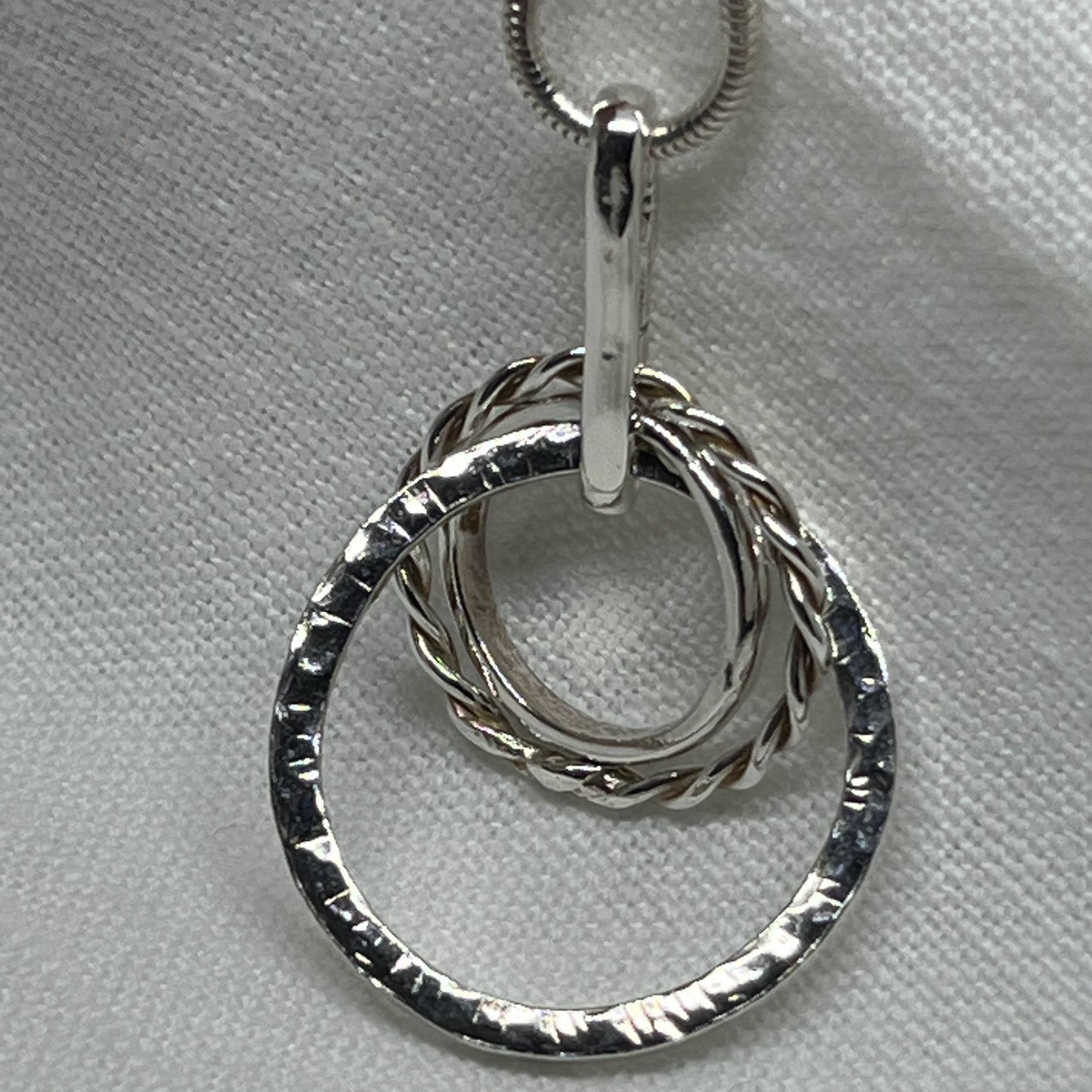 sterling silver mixed loop necklace three different sized rings intertwined