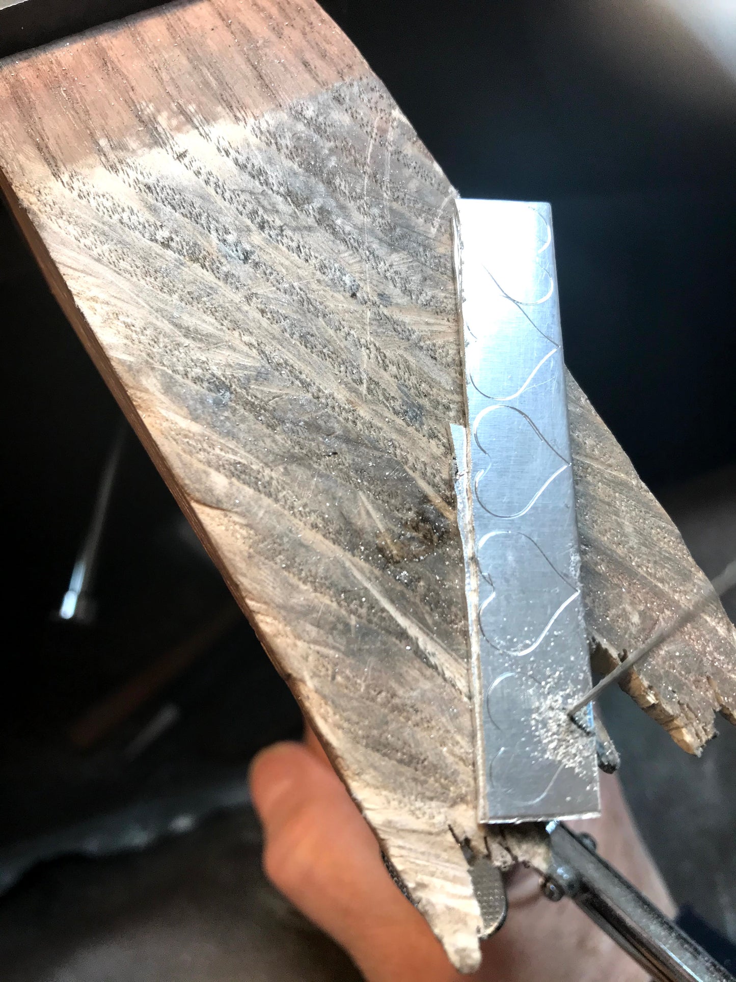 Traditional silver smith cutting silver hearts from a flat piece of sterling silver piercing saw in picture