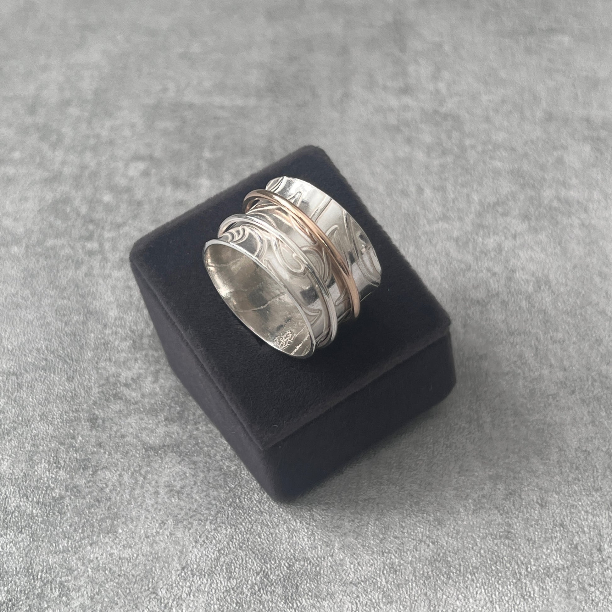 spinner ring sitting on a velvet box