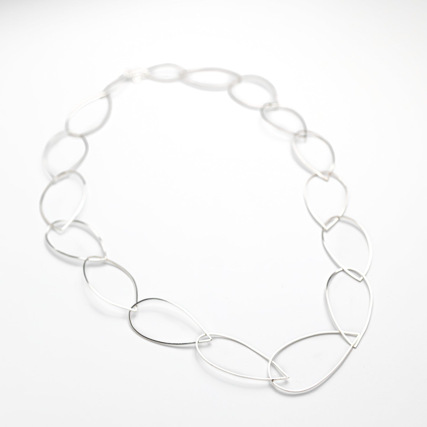 sterling silver necklace on a white silk background