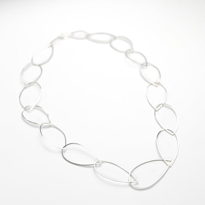 sterling silver necklace on a white silk background