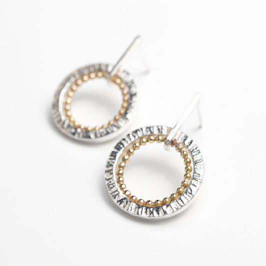 handmade sterling silver and gold earrings. circle with hammered  finish and gold filled beaded circle on the inside