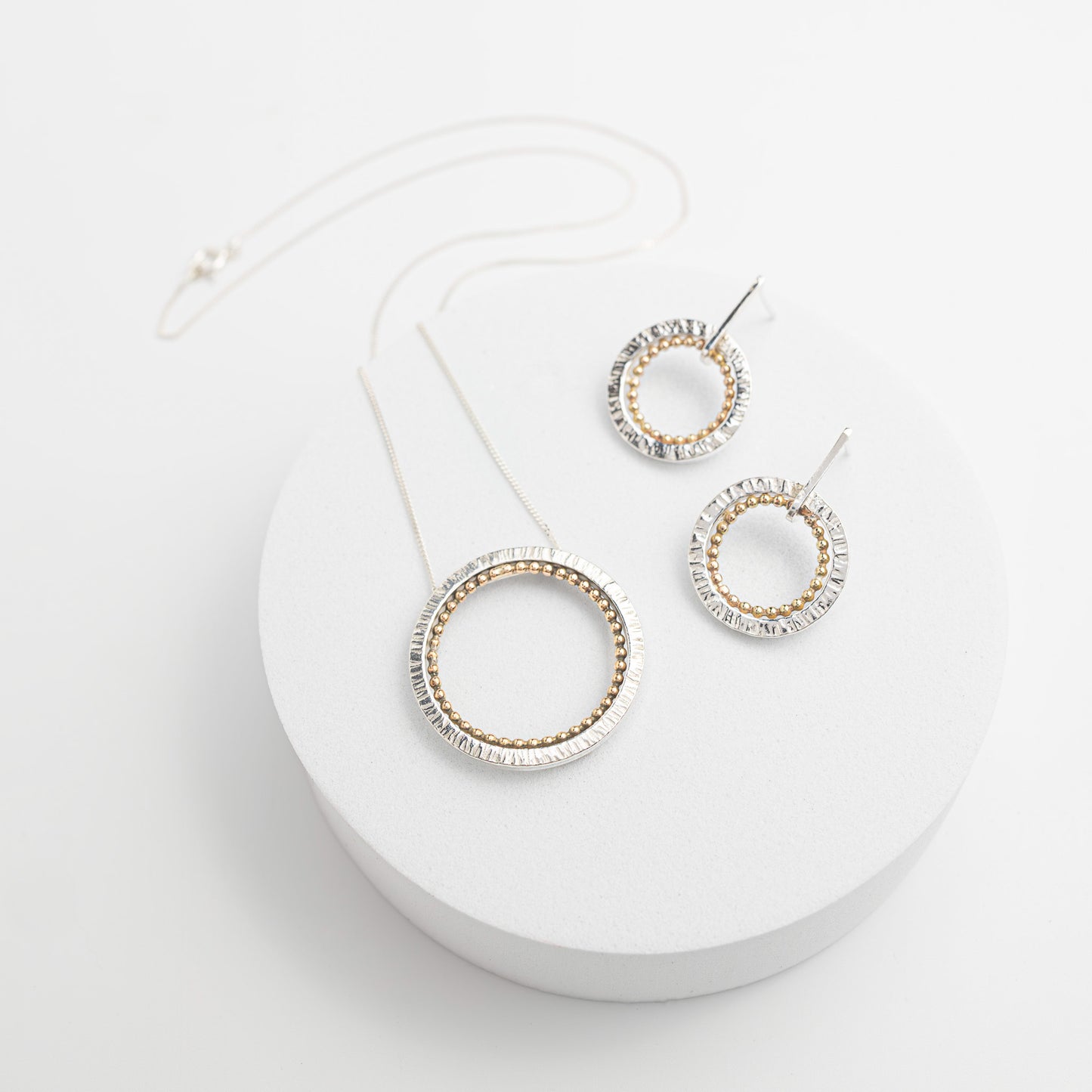 circular display with pendant necklace, sterling silver circle with cold interior