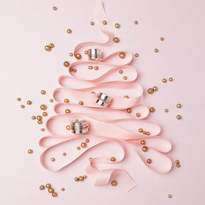 pink decorative ribbon in the shape of a christmas tree with gold balls and three spinner rings