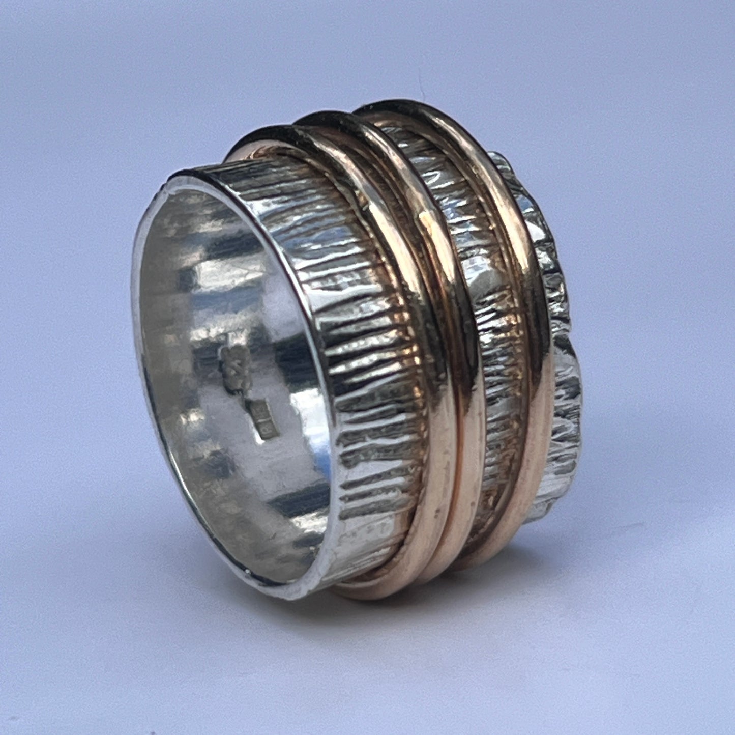 silver ring with gold spinners 