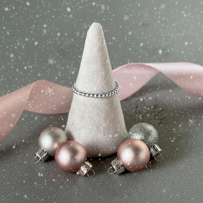 silver ring on a  pink velvet cone