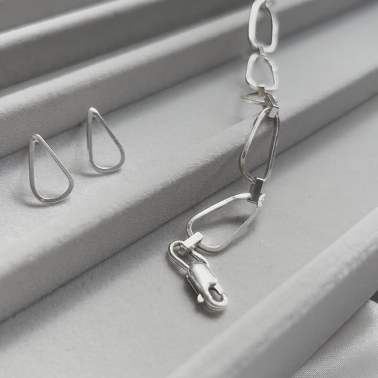 droplet shaped silver earrings with waterflow handmade silver bracelet in a jewellery box