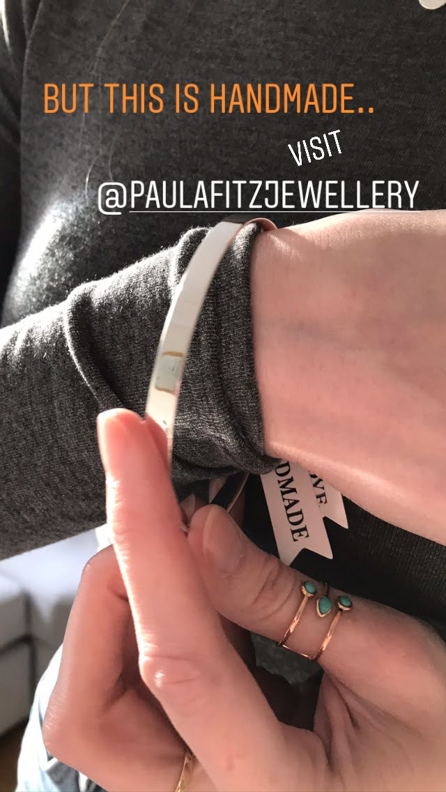 Handmade in Dublin picture model showing her Suzanne bangle on her wrist - wearing  a charcoal grey jumper sterling silver