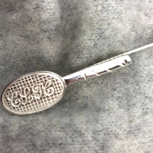 tennis racket brooch pin in the shape of a tennis racket