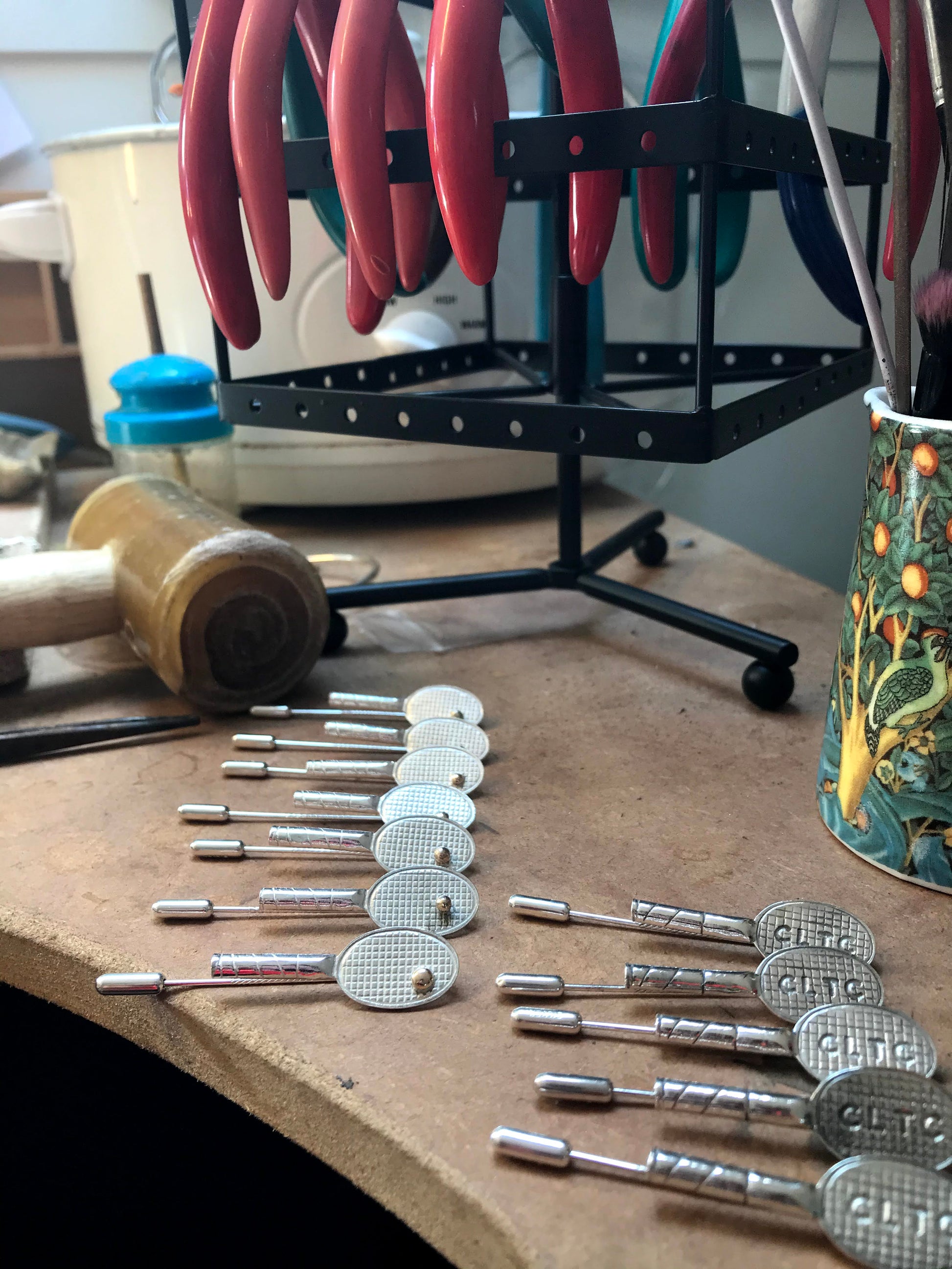 work bench with tennis rackets made from sterling silver