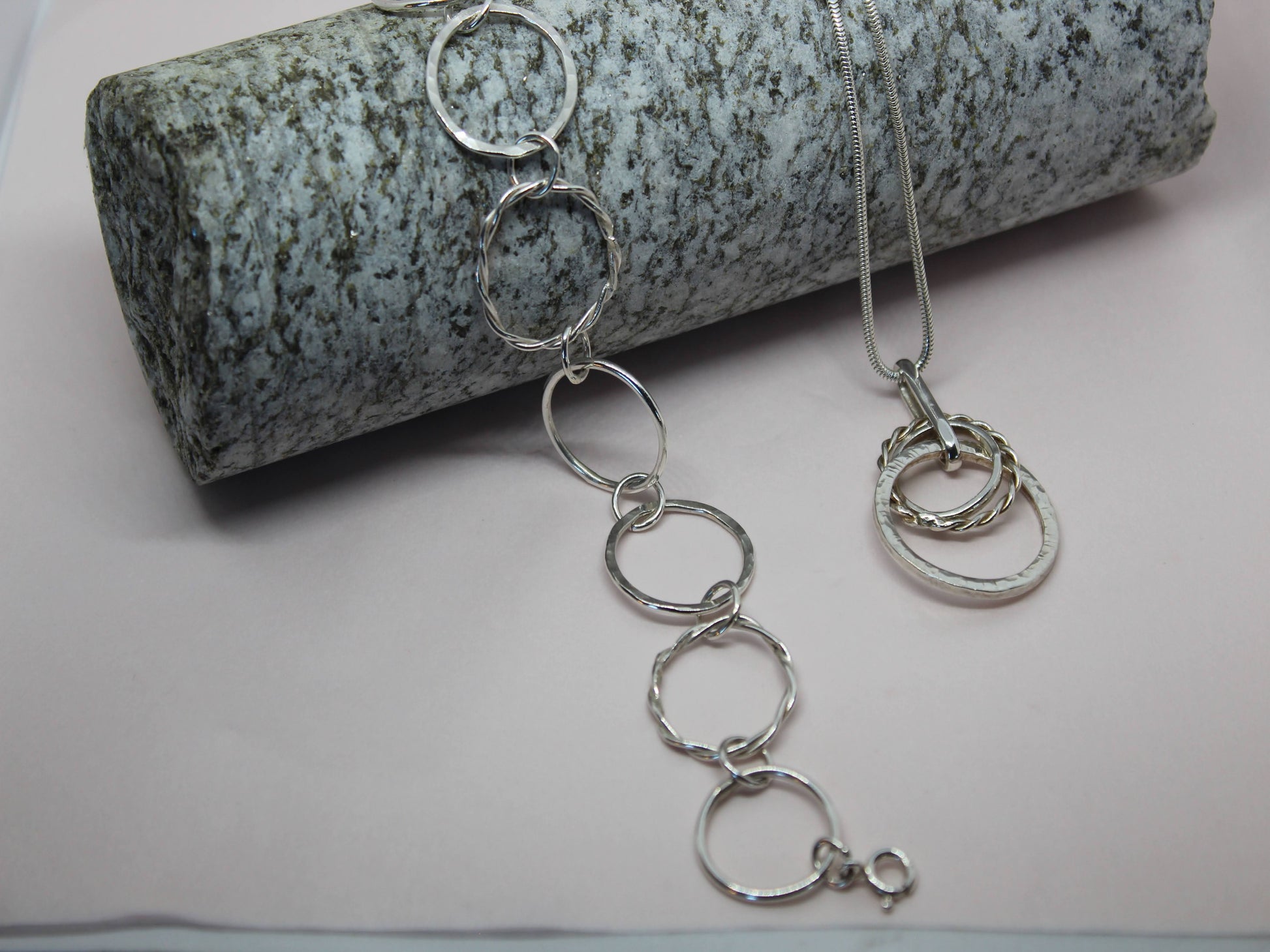 sterling silver mixed loop bracelet and mixed loop necklace on a block of Wicklow granite. 45cm sterling silver snake chain