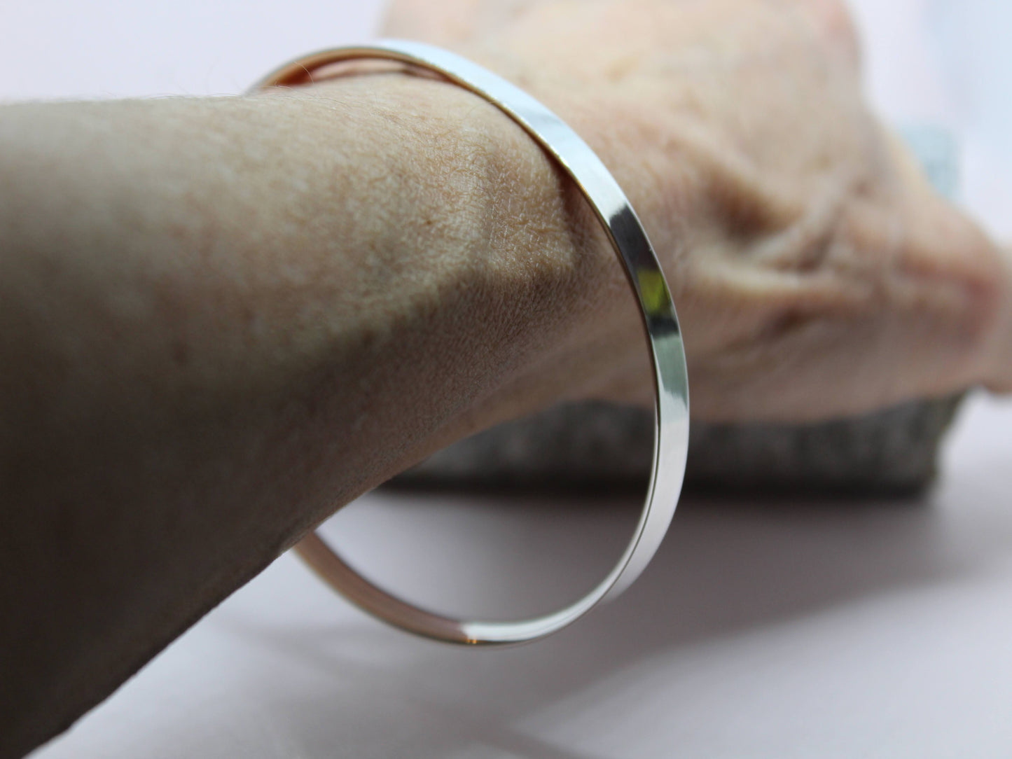 Handmade sterling silver 4mm D shaped silver wire. Elegant and classical solid bangle. Pictured on a wrist - size 23cm