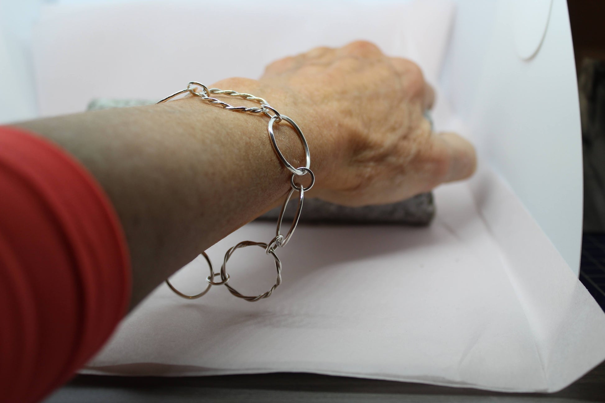 handmade sterling silver mixed loop bracelet. Circles of silver 1.5mm wire highly polished. One twisted one mirror finish one twisted strands to give a rope appearance. Repeat pattern looks great on any arm and can be made to measure or order standard size