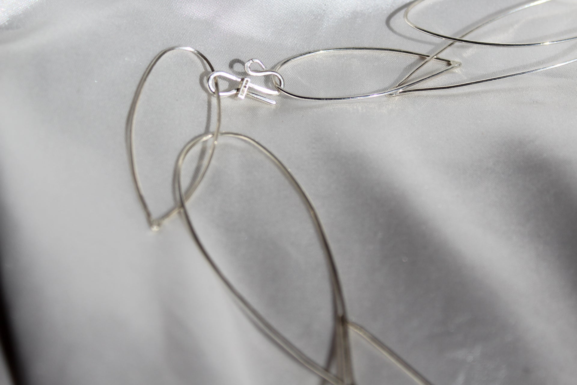 Hall marked sterling silver necklace on a grey silk background
