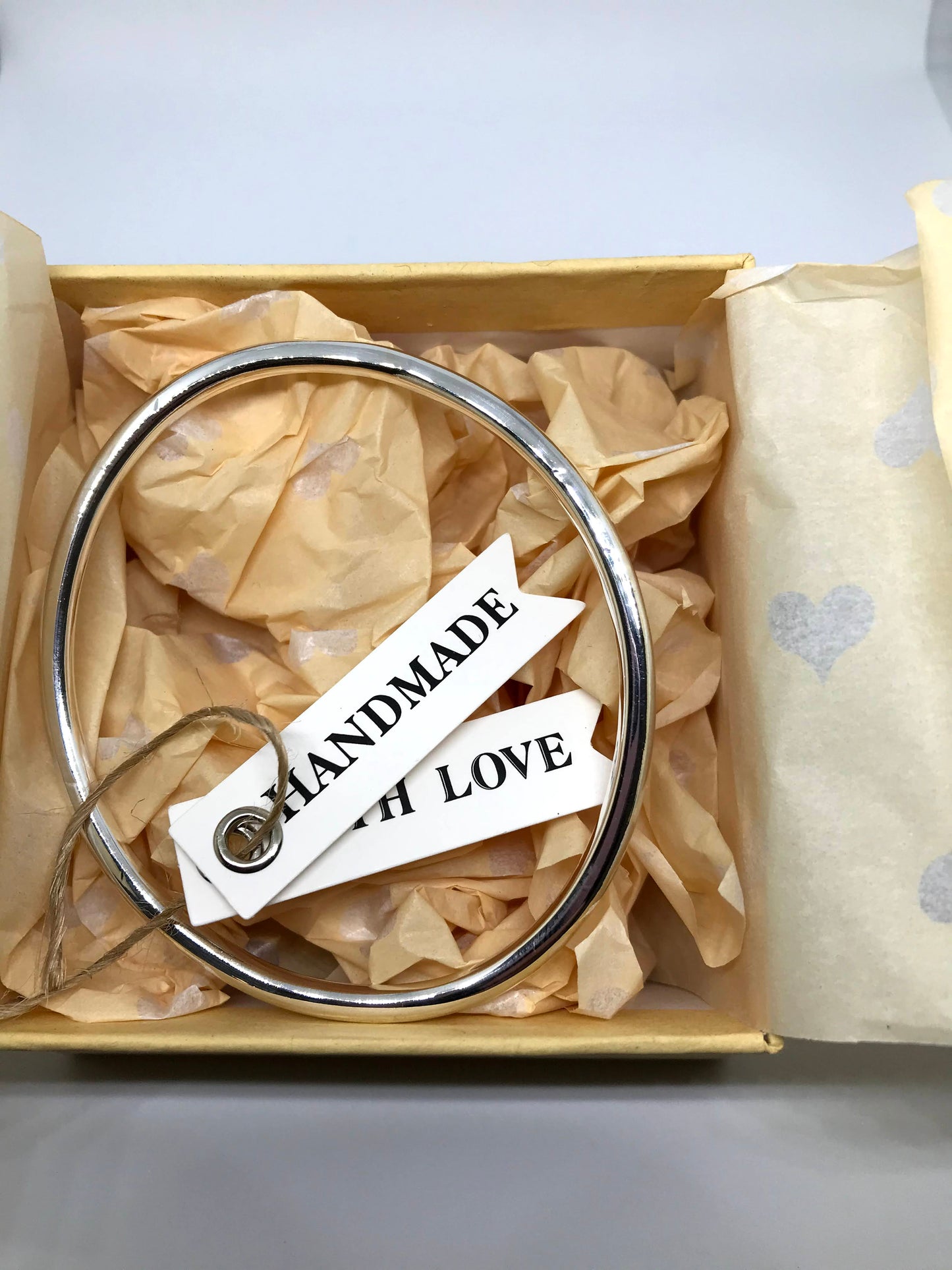 925 sterling silver handmade bangle in a recycled brown cardboard box with cute love heart tissue paper insert