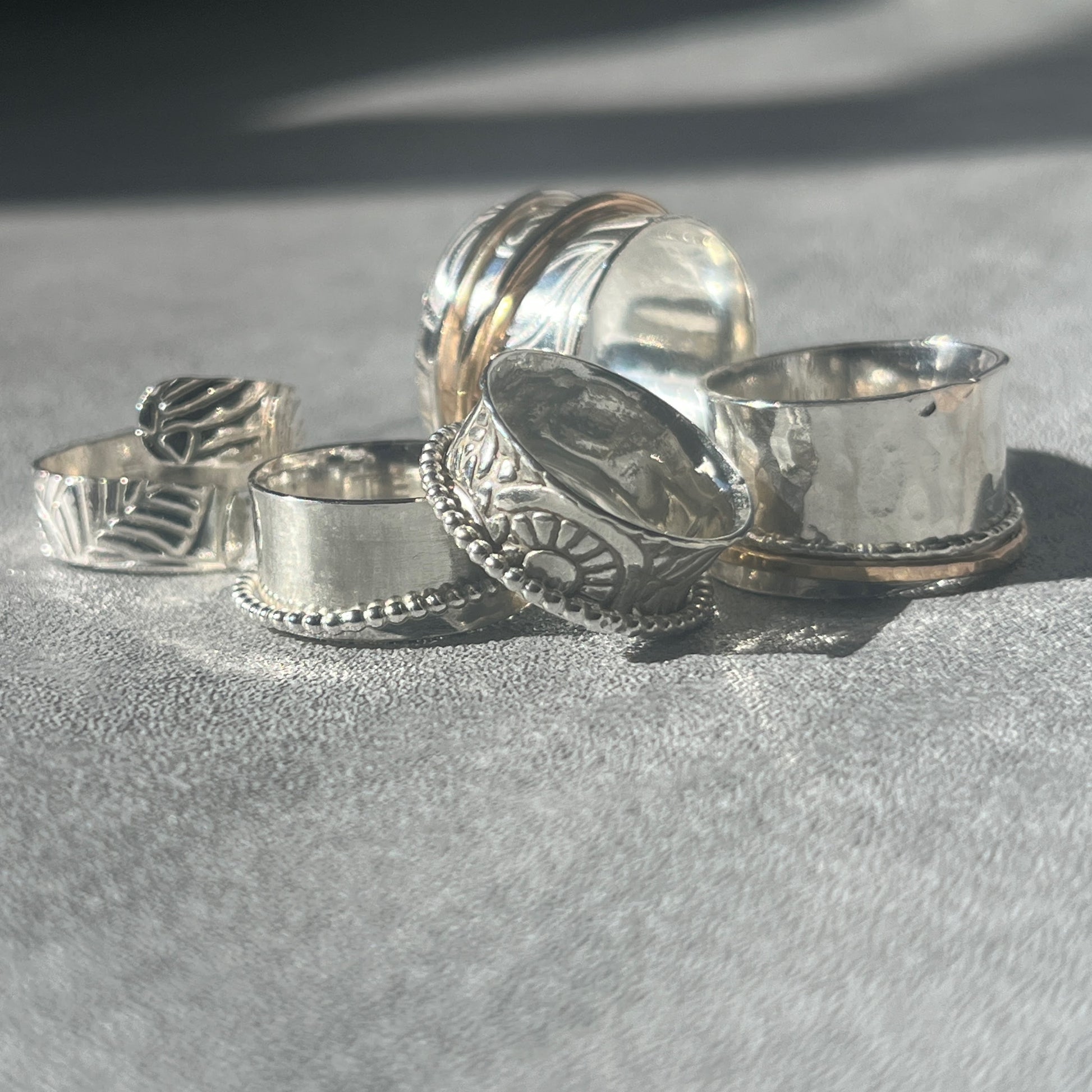 a collection of the various spinner rings available five in the picture in bright light